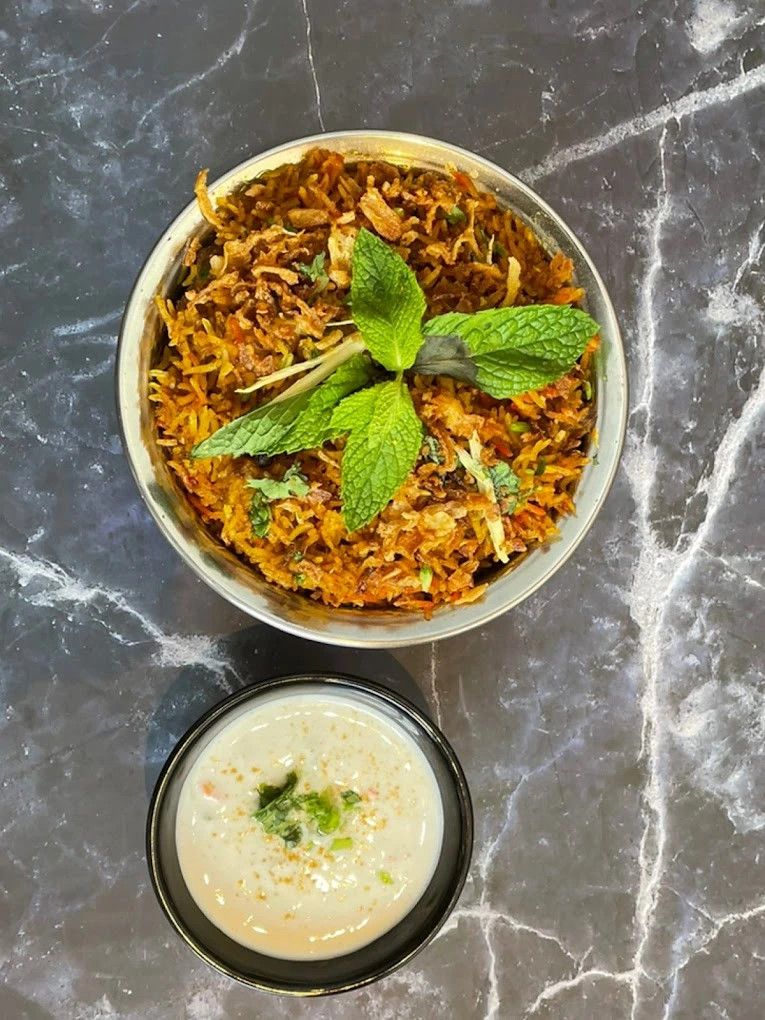 Chicken Biryani at Tandoori Kitchen Edmonton - Fragrant basmati rice with tender marinated chicken and aromatic spices